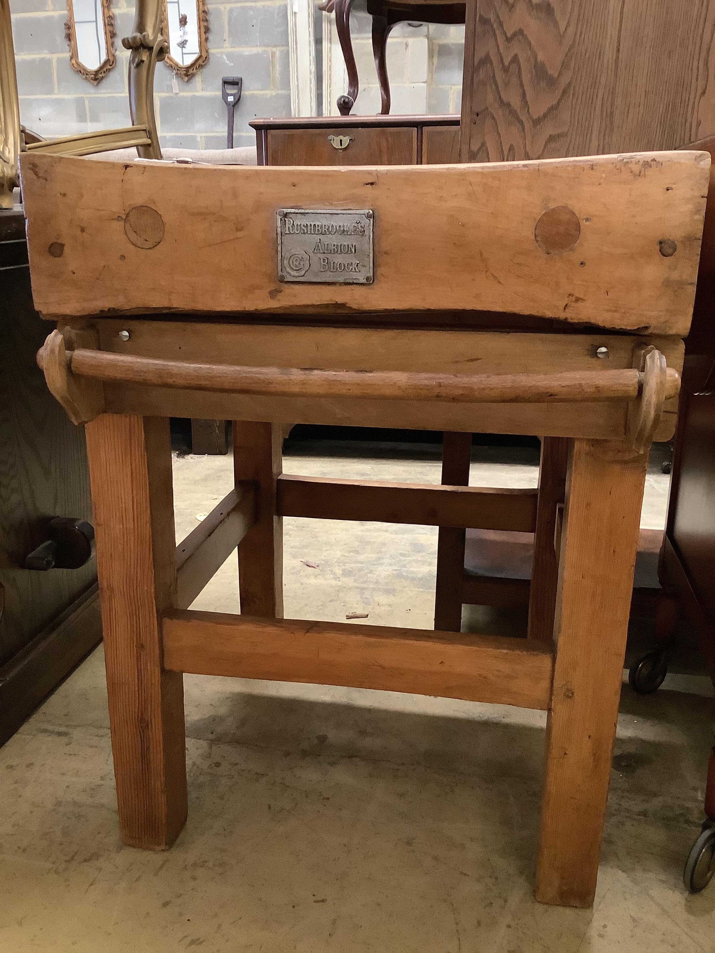 A 'Rushbrookes Albion' butcher's block on pine stand, width 60cm, depth 61cm, height 81cm